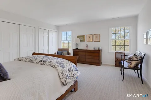 a spacious bedroom with a bed and a couch