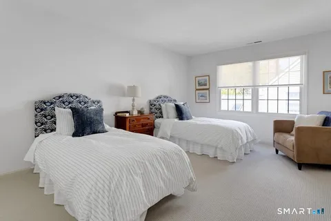 a bedroom with two beds and a large window