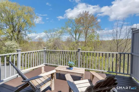 a view of a balcony with wooden floor