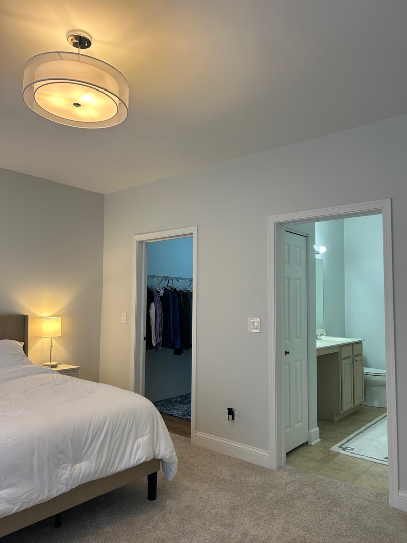 1501 Millbrook Drive Algonquin, IL 60102 - Photo 11 of 19 a bedroom with a bed and a chandelier