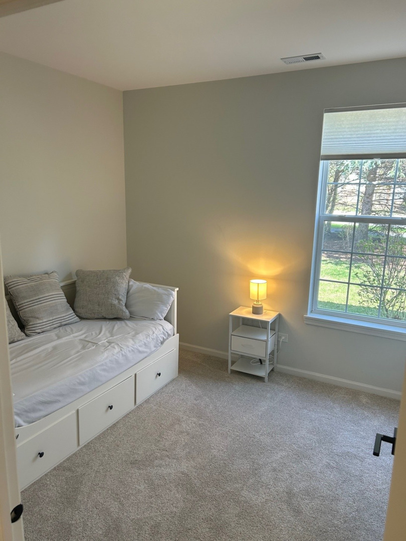 1501 Millbrook Drive Algonquin, IL 60102 - Photo 14 of 19 a spacious bedroom with a bed and a table
