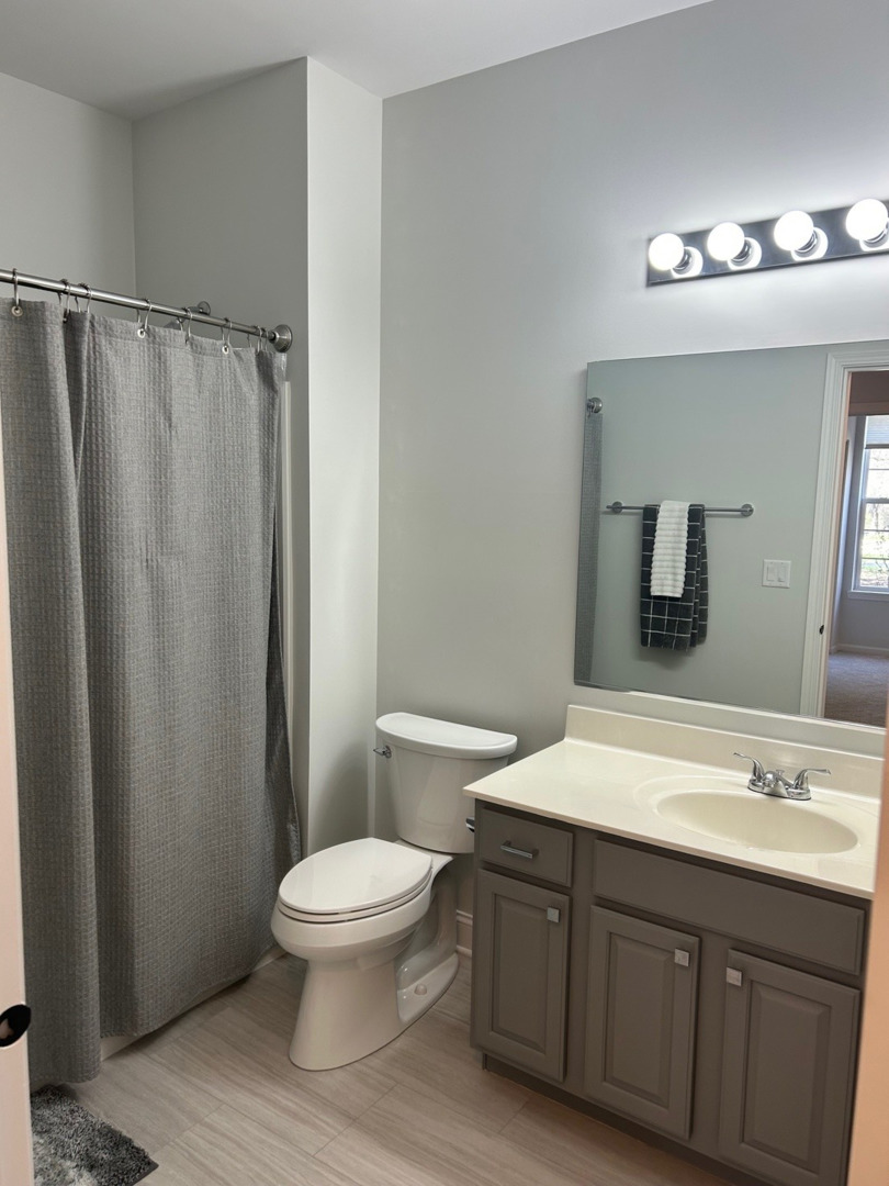 1501 Millbrook Drive Algonquin, IL 60102 - Photo 15 of 19 a bathroom with a double vanity sink toilet and a mirror