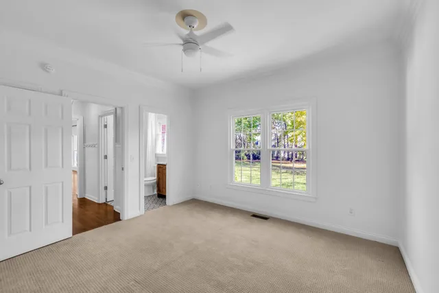 an empty room with windows and closet area