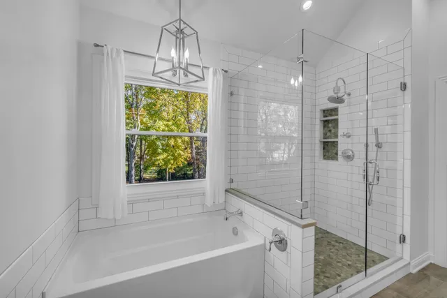 a bathroom with a bathtub and a shower