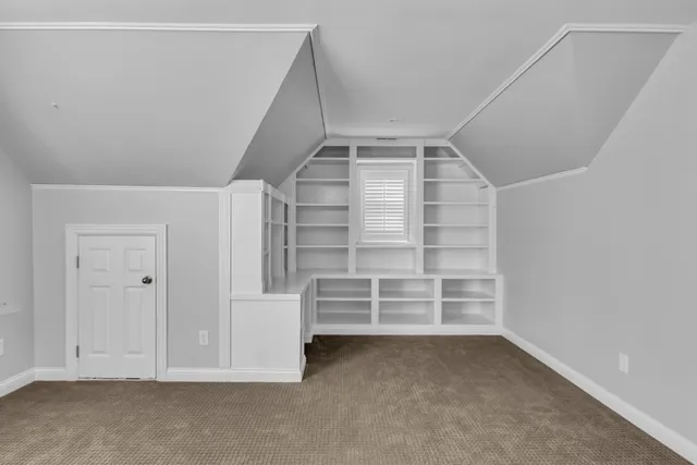 a view of an empty room and stairs