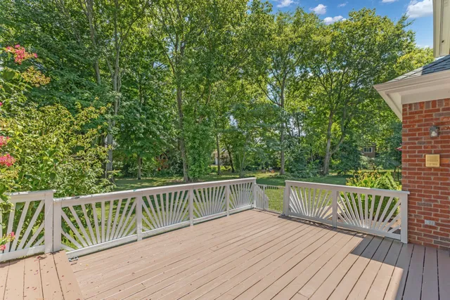 a view of balcony with wooden floor and fence