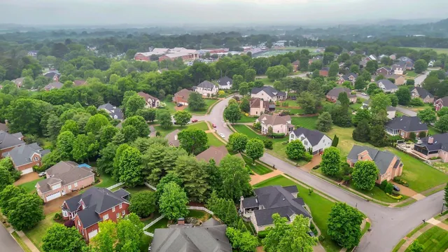 an aerial view of residential houses with outdoor space and street view