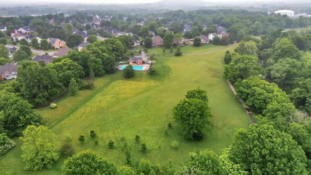 an aerial view of a houses with a yard