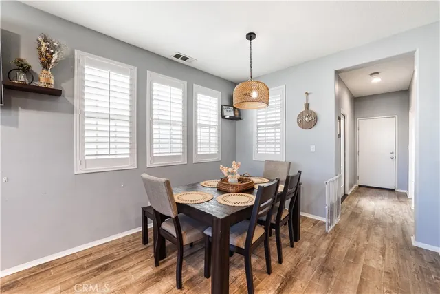 a view of a dining room with furniture window and wooden floor