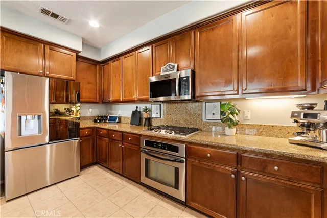a kitchen with a sink window and cabinets