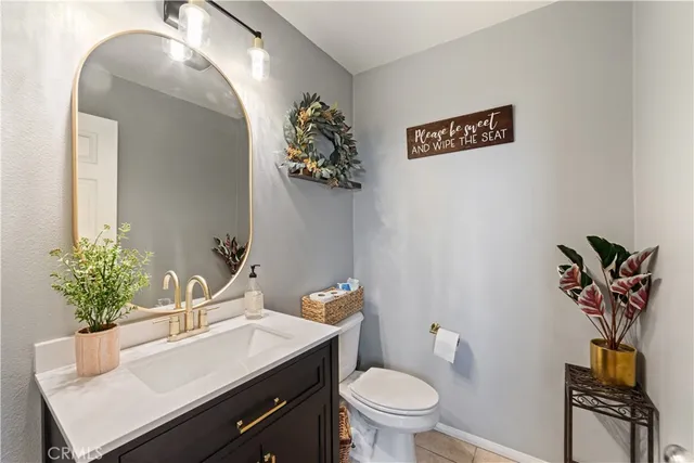 a bathroom with a sink a toilet and mirror