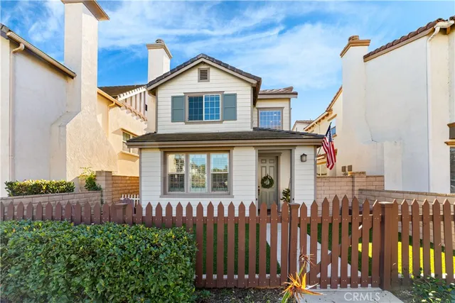 a front view of a house with wooden fence