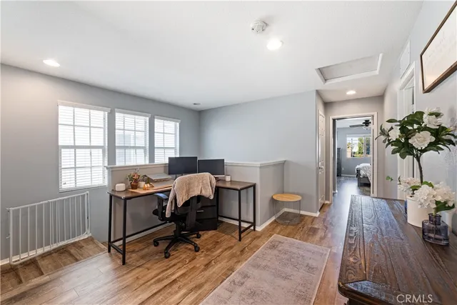 a view of a workspace with furniture and a window
