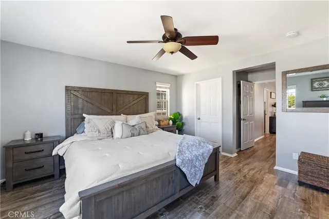 a bed room with a bed and a ceiling fan