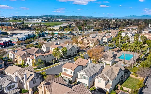 an aerial view of residential houses with outdoor space