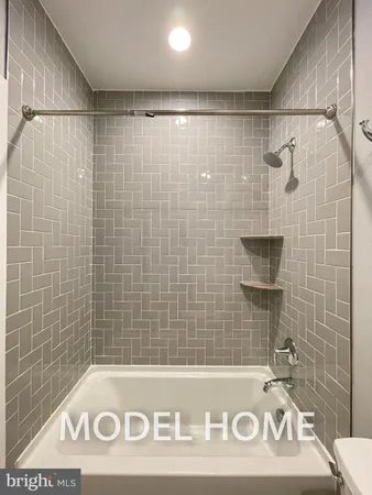 a bathroom with a shower and a sink