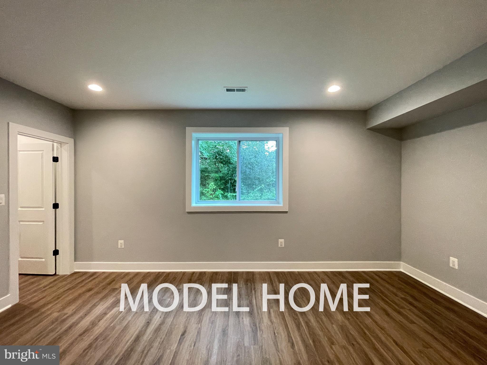 449 Lawyers Road Northwest Vienna, VA 22180 - Photo 41 of 49 a view of an empty room with wooden floor
