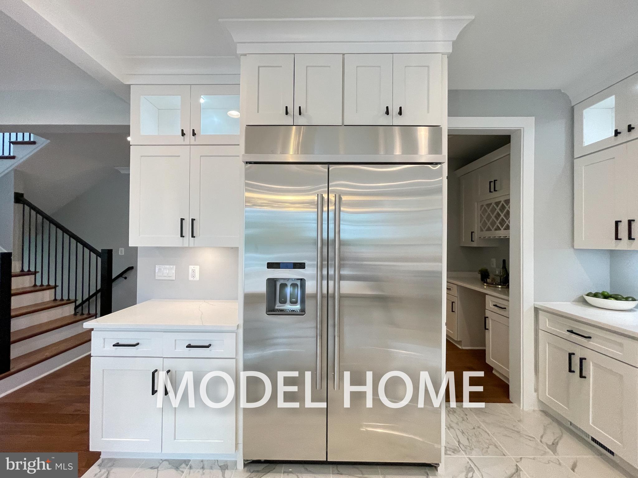 449 Lawyers Road Northwest Vienna, VA 22180 - Photo 10 of 49 a kitchen with kitchen island a stove a refrigerator and white cabinets