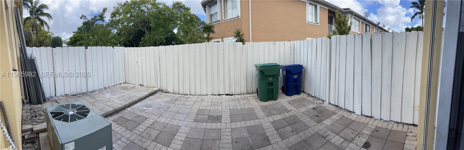 7020 Northwest 177th Street, Unit B103 Hialeah, FL 33015 - Photo 14 of 53 a view of a backyard with wooden fence