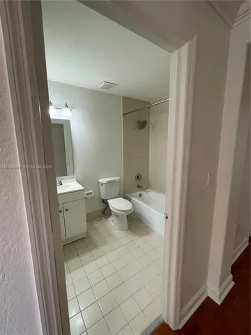 a bathroom with a double vanity sink toilet and shower