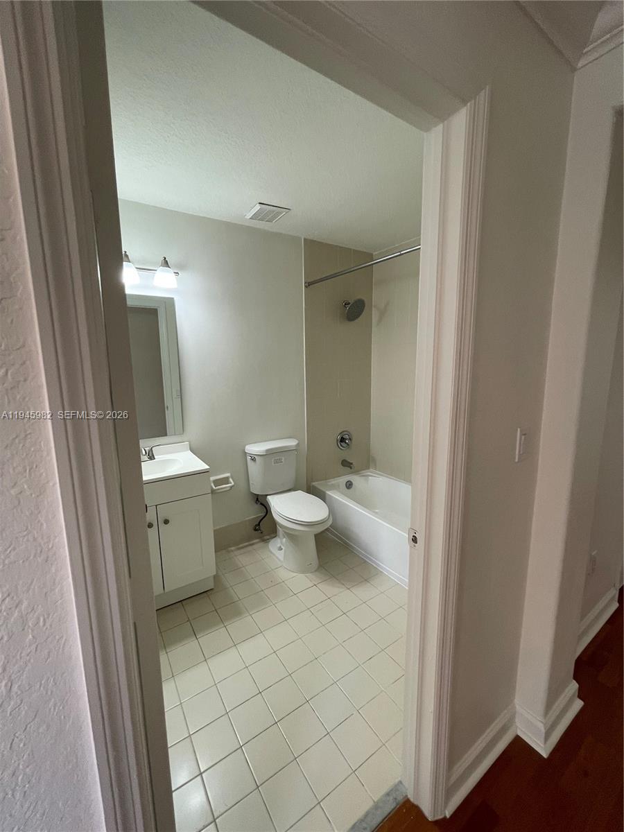 7020 Northwest 177th Street, Unit B103 Hialeah, FL 33015 - Photo 19 of 53 a bathroom with a toilet sink and mirror