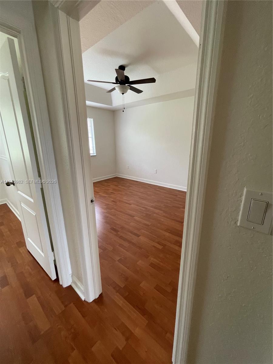 7020 Northwest 177th Street, Unit B103 Hialeah, FL 33015 - Photo 20 of 53 a view of a hallway with wooden floor