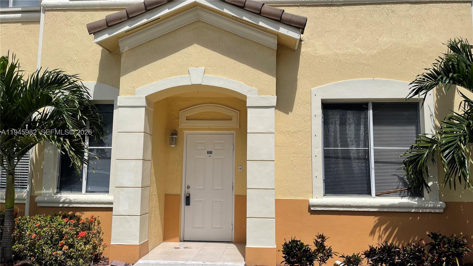7020 Northwest 177th Street, Unit B103 Hialeah, FL 33015 - Photo 28 of 53 a front view of a house with a window