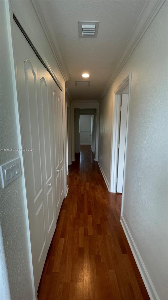7020 Northwest 177th Street, Unit B103 Hialeah, FL 33015 - Photo 42 of 53 a view of a hallway with wooden floor