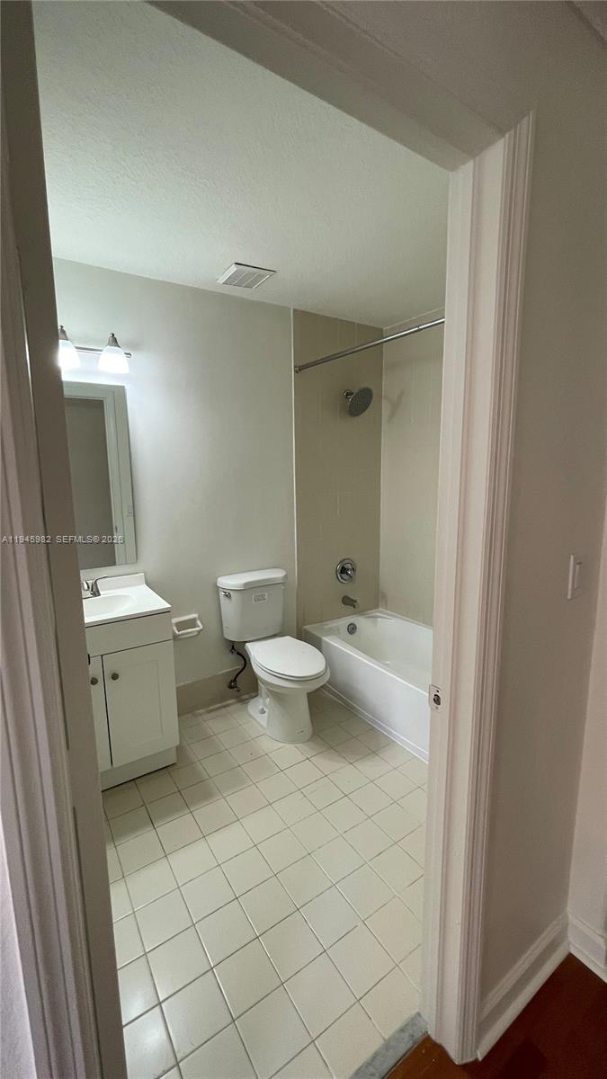 7020 Northwest 177th Street, Unit B103 Hialeah, FL 33015 - Photo 46 of 53 a bathroom with a toilet sink and mirror