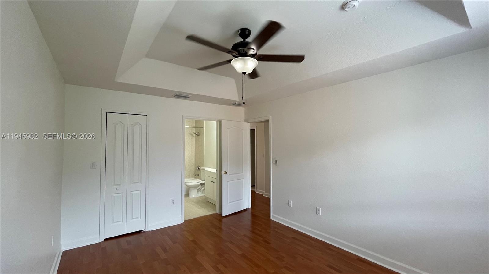7020 Northwest 177th Street, Unit B103 Hialeah, FL 33015 - Photo 50 of 53 a view of empty room with wooden floor and ceiling fan
