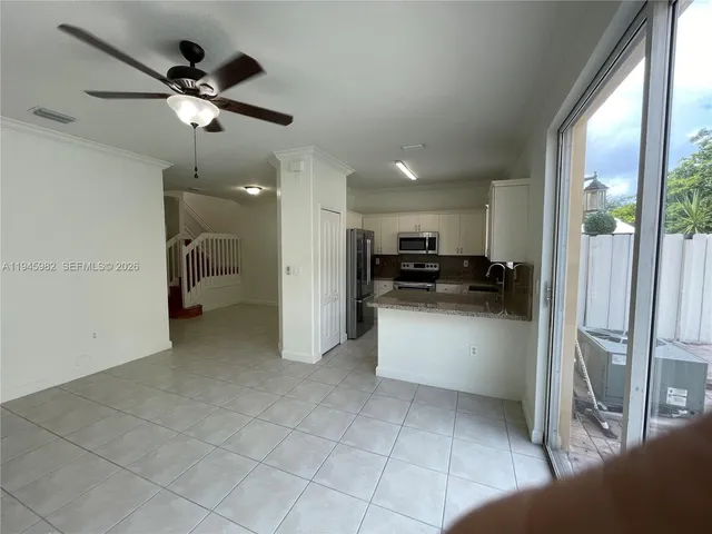 a kitchen with granite countertop a refrigerator and a sink