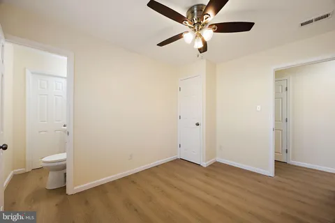 a view of an empty room and wooden floor