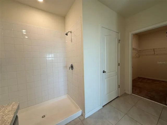a bathroom with a tub and shower