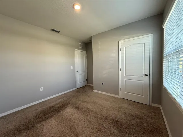 an empty room with closet area