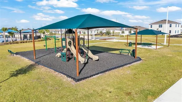 an aerial view of a house with a yard and large trees