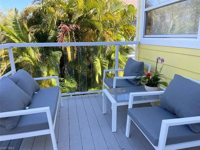 a balcony with wooden floor and furniture