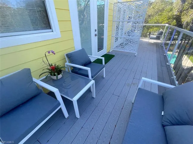 a living room with furniture a rug and a large window