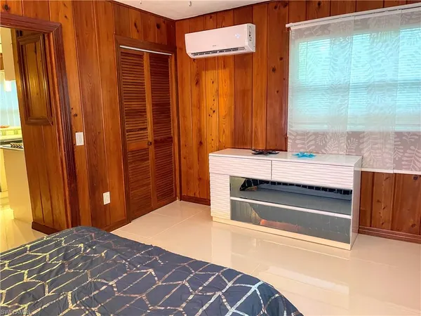 a living room with furniture a large window with kitchen view