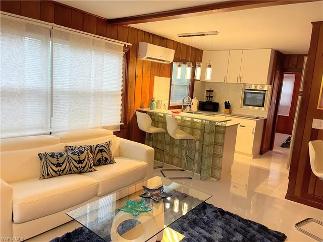 a living room with a bed furniture and a window