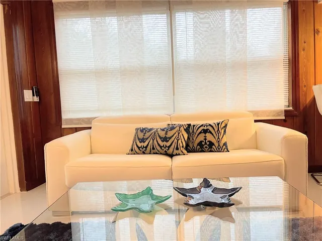 a dining room with furniture and chandelier
