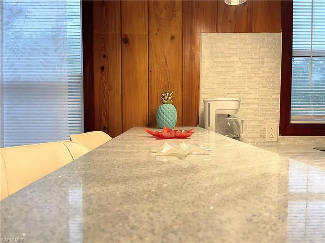 a kitchen with stainless steel appliances granite countertop a sink and a wooden cabinets