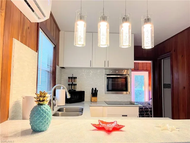 a kitchen with a sink a stove and cabinets