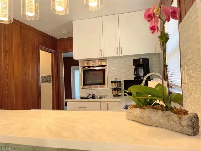 a kitchen with a refrigerator and a sink