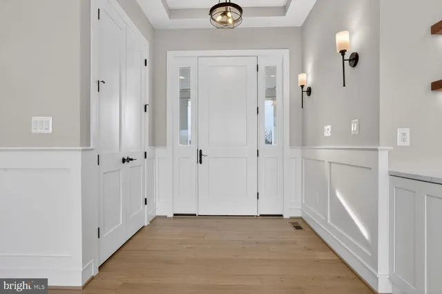 a view of a kitchen with stainless steel appliances a refrigerator and a stove top oven
