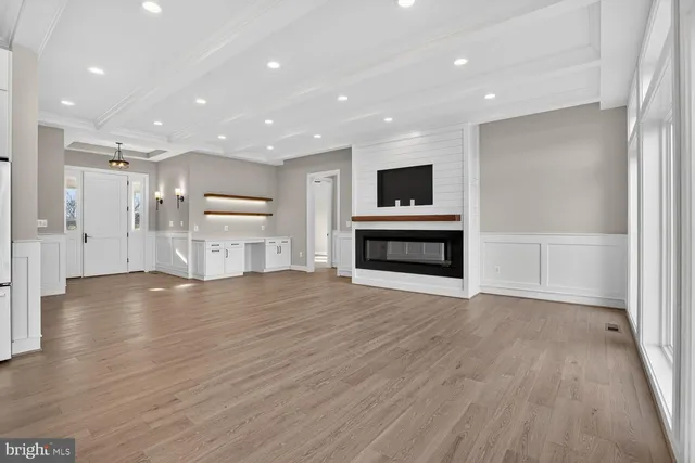 a kitchen with kitchen island a sink a stove and wooden floor