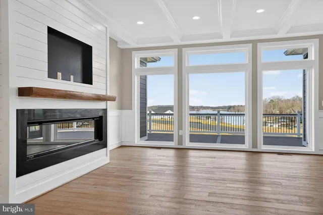 a large kitchen with stainless steel appliances kitchen island granite countertop a stove and a large window