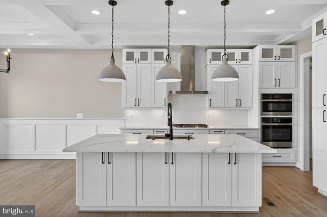 a kitchen with stainless steel appliances kitchen island a large island in the center