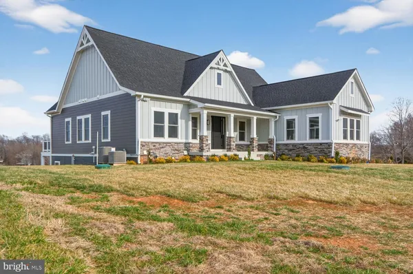 a front view of house with yard porch and furniture