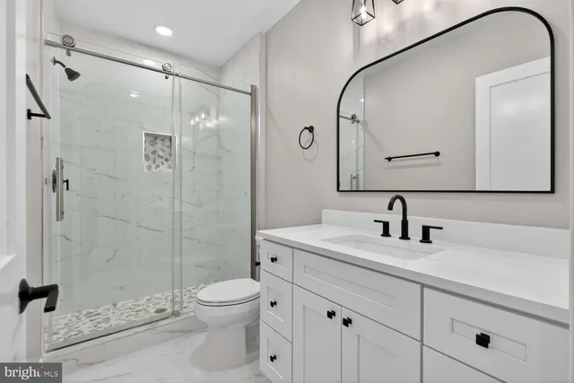 a kitchen with kitchen island white cabinets and stainless steel appliances