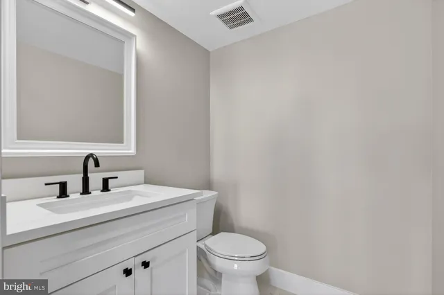 a view of empty room with wooden floor and fireplace